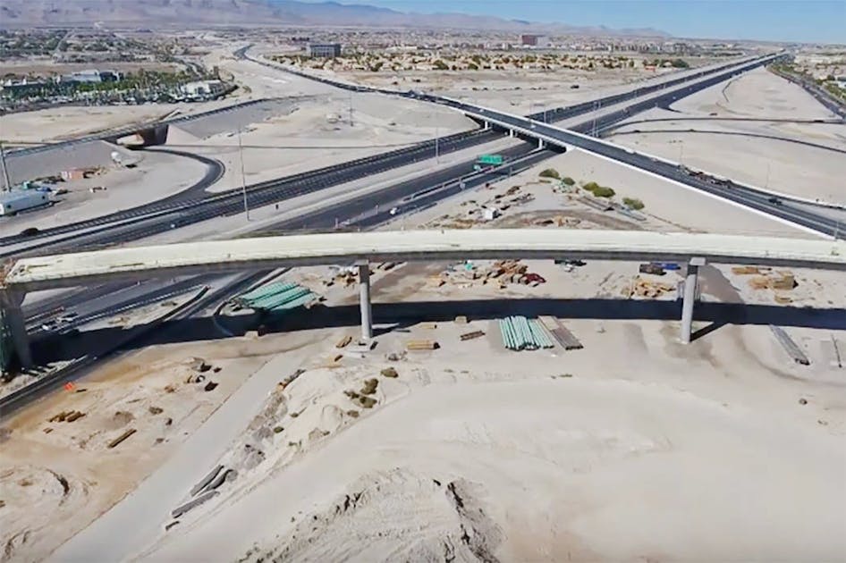 Employees with the Nevada Department of Transportation and Las Vegas Paving  Corp. celebrate the opening of the Centennial Bowl flyover bridge linking  westbound 215 Beltway and southbound U.S. High …