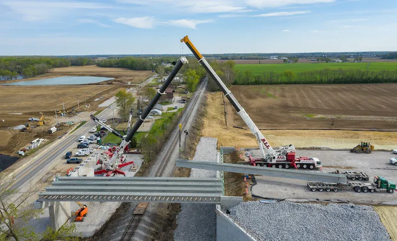 Use of rigging triangle eases repeated handoffs of concrete bridge ...