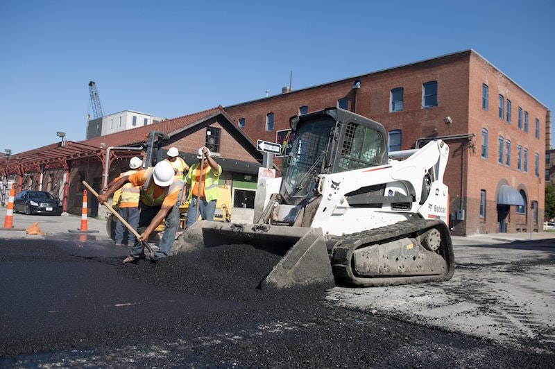low-res-bobcat-t870-bucket-asphalt-paving-workers