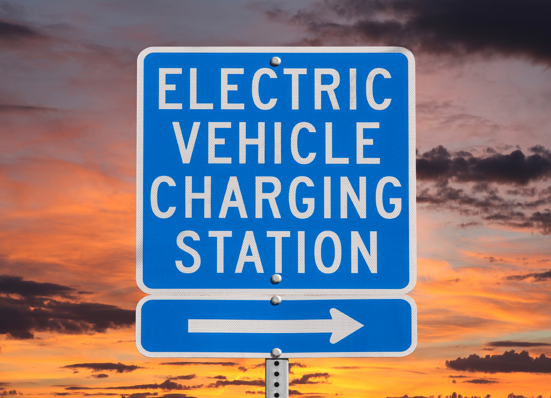 Electric Vehicle Charging Station Sign With Sunset Sky Trekandshoot 62ea894cb4796