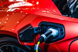 Red Ev Car At Charging Station With The Power Cable Supply Plugged In 62e931dceb369 Red Ev Car At Charging Station With The Power Cable Supply Plugged In 62e931dceb369