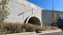 The completed TechSpan tunnel and a Reinforced Earth MSE wall with the final stone veneer.