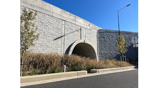 The completed TechSpan tunnel and a Reinforced Earth MSE wall with the final stone veneer.
