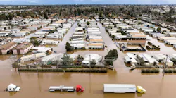 Trucks and homes are partially submerged in a flooded neighborhood in Merced, Calif. on Jan. 10, 2023.