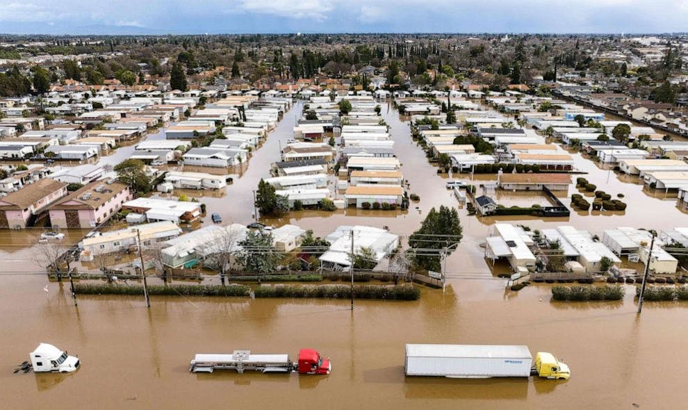 Trucks and homes are partially submerged in a flooded neighborhood in Merced, Calif. on Jan. 10, 2023.