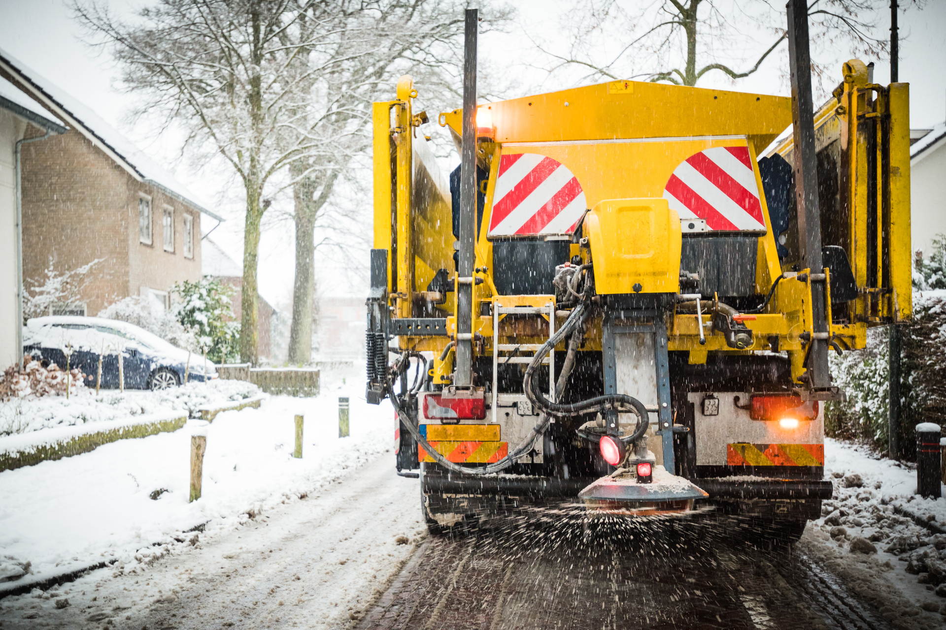 Winter road maintenance truck spreading salt and sand