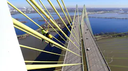 An engineer performs visual assessment of a cable on the southbound bridge using rope access.