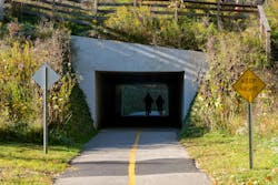 Cyclists pass through a tunnel on a biking path in Ohio's Cuyahoga Valley National Park. Cyclists pass through a tunnel on a biking path in Ohio's Cuyahoga Valley National Park.