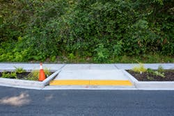 A sidewalk with a bump out, also known as a curb extension. A sidewalk with a bump out, also known as a curb extension.