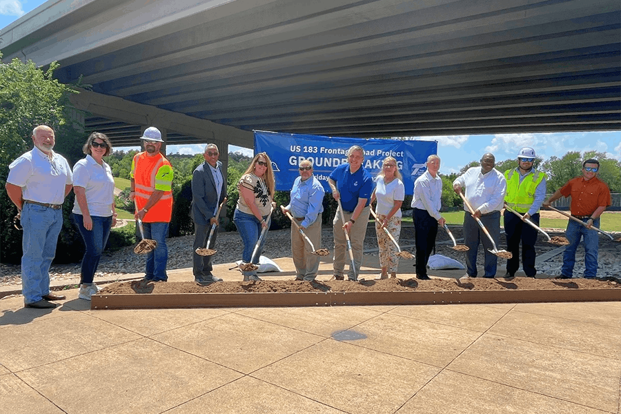 City, county and TxDOT officials pose for a ceremonial groundbreaking photo celebrating the addition of frontage roads along Toll 183A in Cedar Park, Texas.