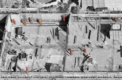 Construction workers laying out a new bridge, working in their various job functions. Construction workers laying out a new bridge, working in their various job functions.