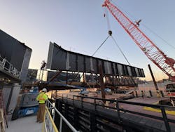 Construction workers are using a crane to drop in the girders for a bridge replacement in New Jersey. Construction workers are using a crane to drop in the girders for a bridge replacement in New Jersey.