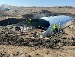 Construction workers building a new buried bridge in Iowa. Construction workers building a new buried bridge in Iowa.