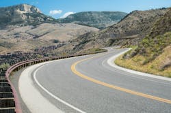 A mountain road winding through the mountains of Bighorn National Forest in northeastern Wyoming. A mountain road winding through the mountains of Bighorn National Forest in northeastern Wyoming.