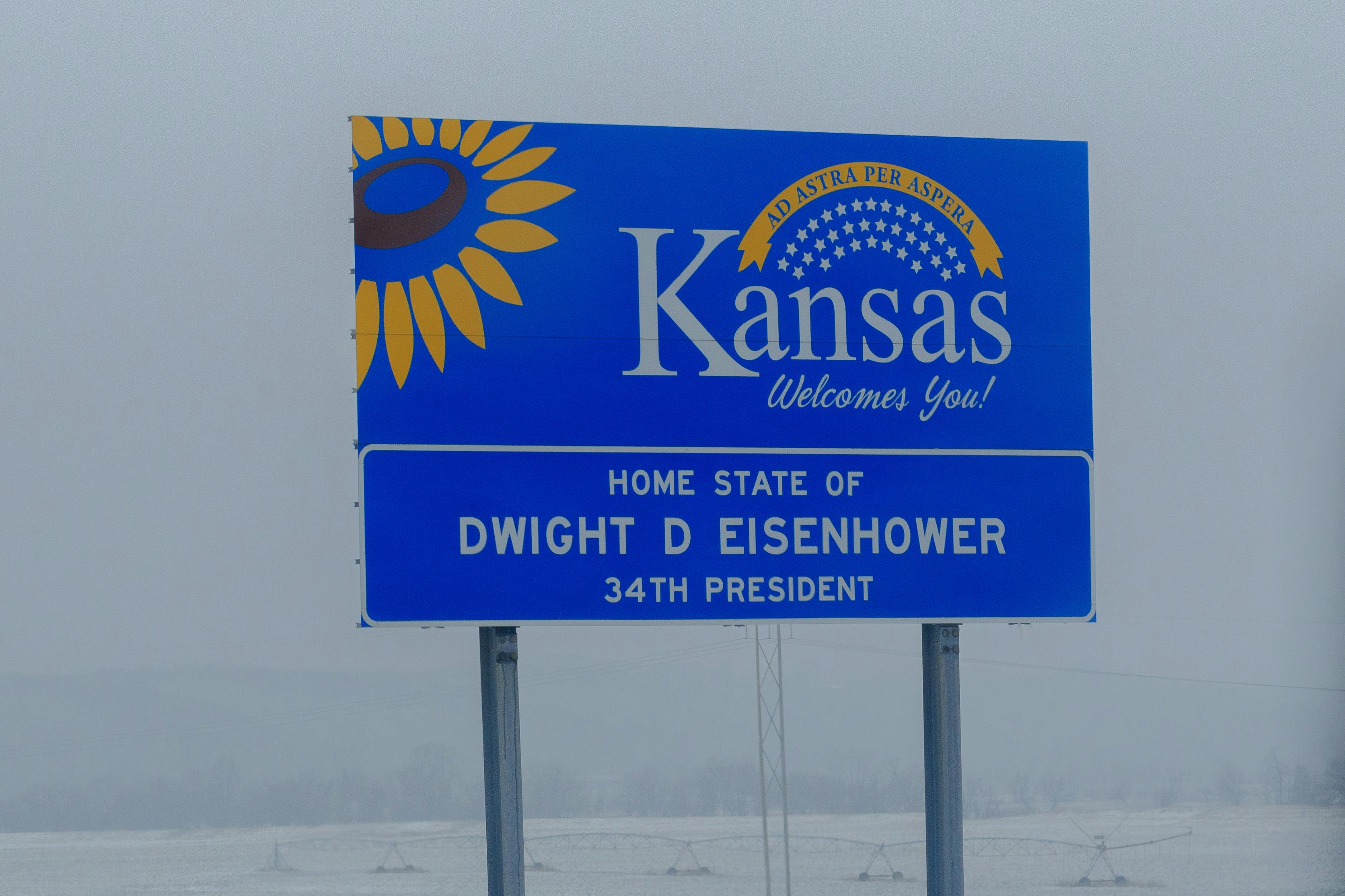 A road sign welcoming drivers to the state of Kansas, home to Dwight D. Eisenhower.