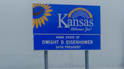 A road sign welcoming drivers to the state of Kansas, home to Dwight D. Eisenhower.
