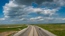 A rural Kansas roadway running through the Great Plains.