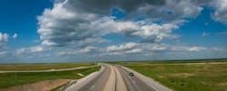 A rural Kansas roadway running through the Great Plains. A rural Kansas roadway running through the Great Plains.