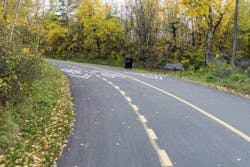 A shared use pathway through a green area. A shared use pathway through a green area.