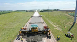 Crews using machinery to complete an accelerated concrete overlay on Iowa Highway 3.