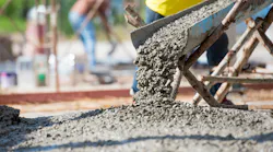 Concrete being poured onto a roadway.