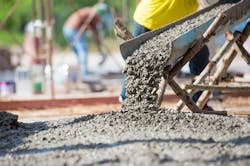 Concrete being poured onto a roadway. Concrete being poured onto a roadway.