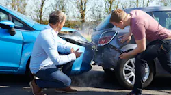 Two drivers arguing following a car crash.