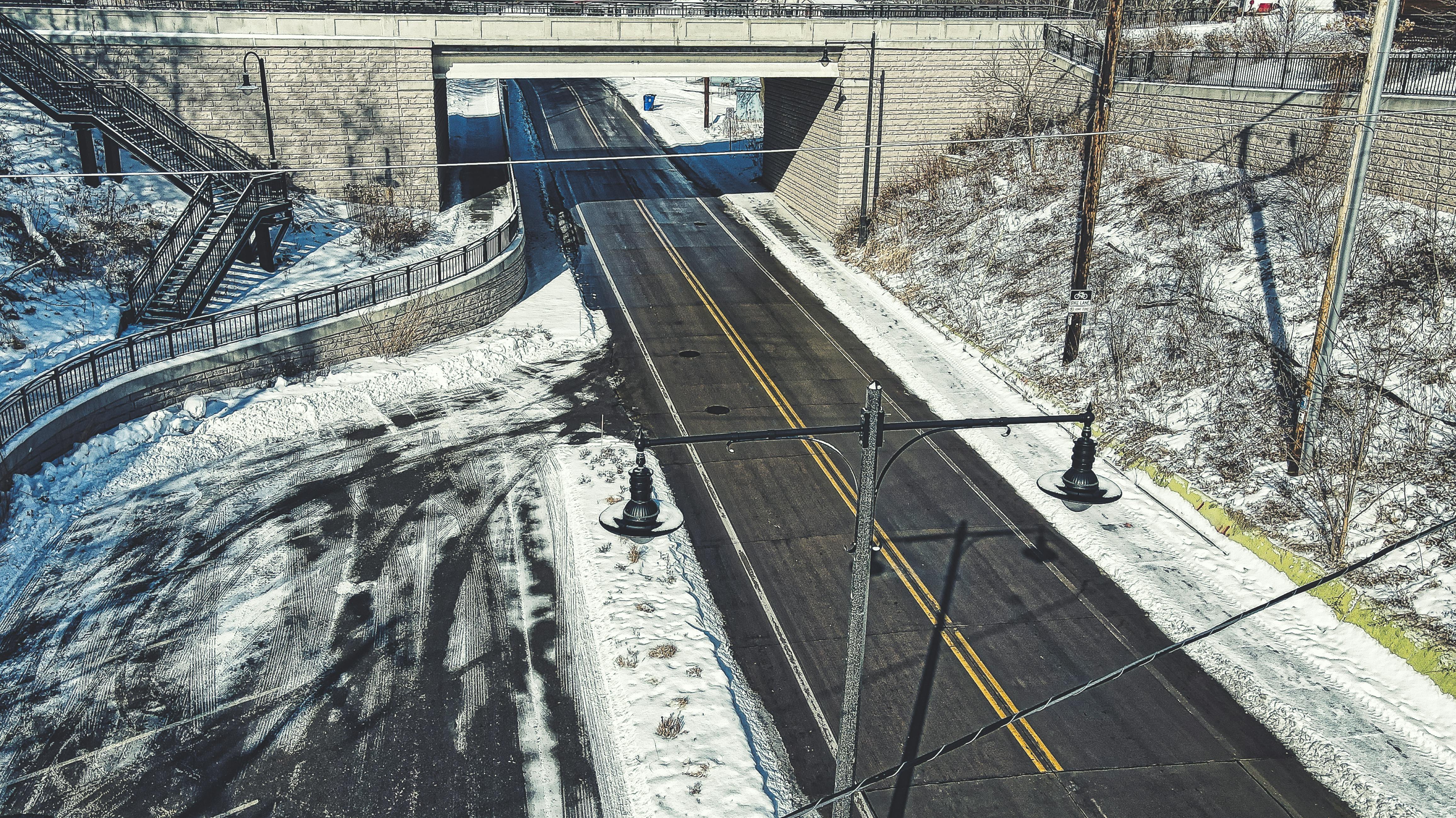 A roadway flanked by snow and ice.