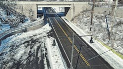 A roadway flanked by snow and ice. A roadway flanked by snow and ice.