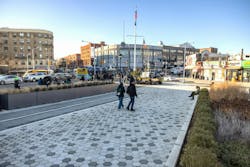 Pedestrians walking on the sidewalk at the revamped Monsignor Raul Del Valle Square in Hunts Point, Bronx Pedestrians walking on the sidewalk at the revamped Monsignor Raul Del Valle Square in Hunts Point, Bronx