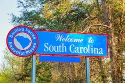 A Welcome to South Carolina sign on the side of the roadway. A Welcome to South Carolina sign on the side of the roadway.