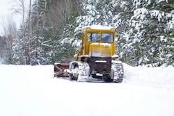 A road grader being used for snow and ice removal A road grader being used for snow and ice removal