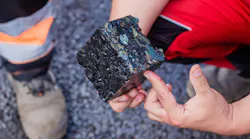 A cube of asphalt taken from the roadway.