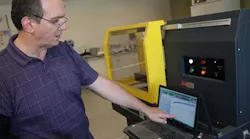 Brian Paroda pointing at a laptop displaying test results.