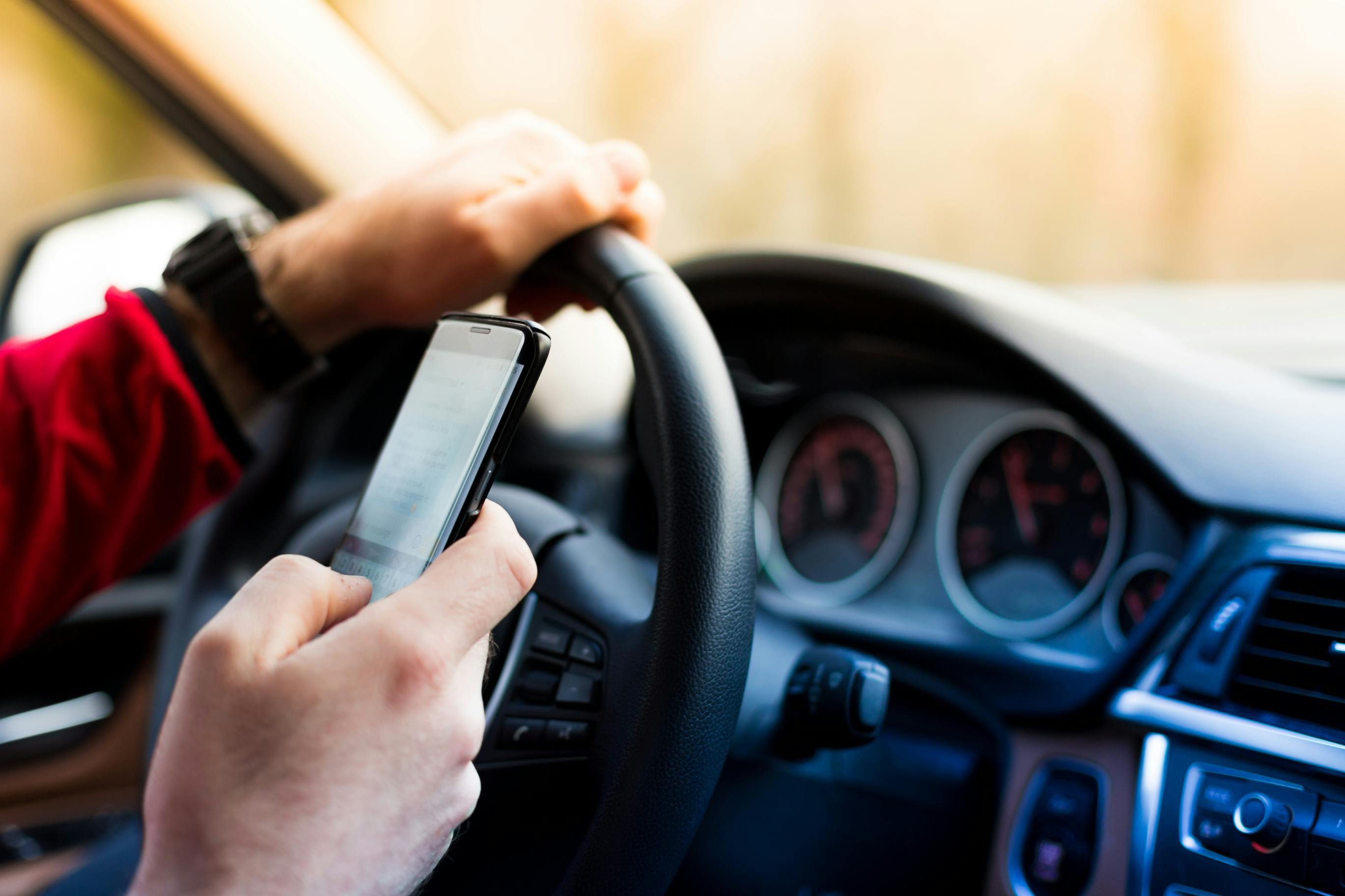 Stock photo of driver texting while driving