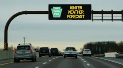 Electronic road sign on Pennsylvania Turnpike warns drivers of winter weather forecast
