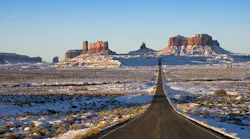The roadway entering Monument Valley Navajo Tribal Park on the border between Utah and Arizona.