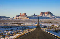 The roadway entering Monument Valley Navajo Tribal Park on the border between Utah and Arizona.