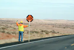 Construction crew man controling traffic Construction crew man controling traffic