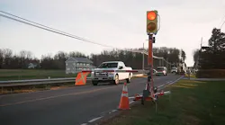 Connected work zone equipment on the side of a roadway blocking traffic on one side.