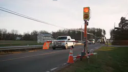 Connected work zone equipment on the side of a roadway blocking traffic on one side. Connected work zone equipment on the side of a roadway blocking traffic on one side.