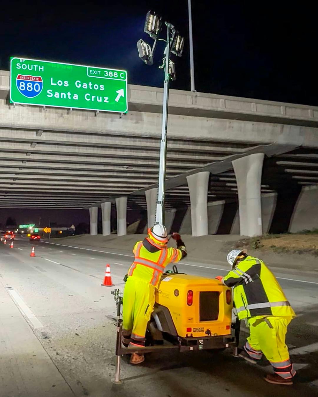 Crews working on a highway at night.