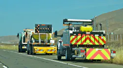A TMA traveling in the shoulder of a highway during road work.