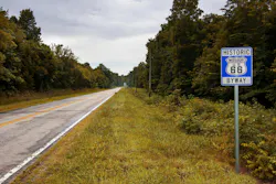 A stretch of the original route 66 with a road sign in a rural area of Missouri A stretch of the original route 66 with a road sign in a rural area of Missouri