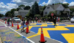 Children cross a street that has implemented traffic calming measures in Worcester, Mass. Children cross a street that has implemented traffic calming measures in Worcester, Mass.