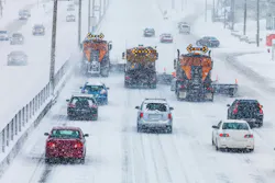Traffic behind a fleet of plows on a snowy highway. Traffic behind a fleet of plows on a snowy highway.