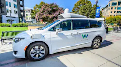 A Waymo van on a roadway.