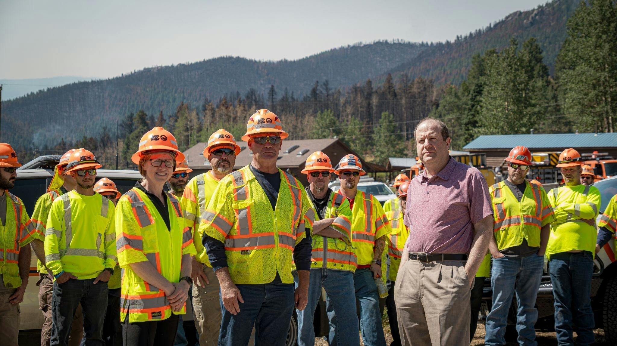 Colorado Gov. Jared Polis and crew members who helped restore the bridge