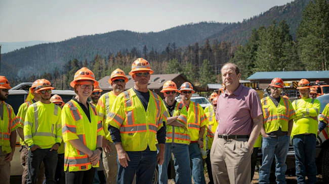 Colorado Gov. Jared Polis and crew members who helped restore the bridge