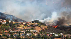 The Palisades wildfire seen burning on a hillside in 2025.